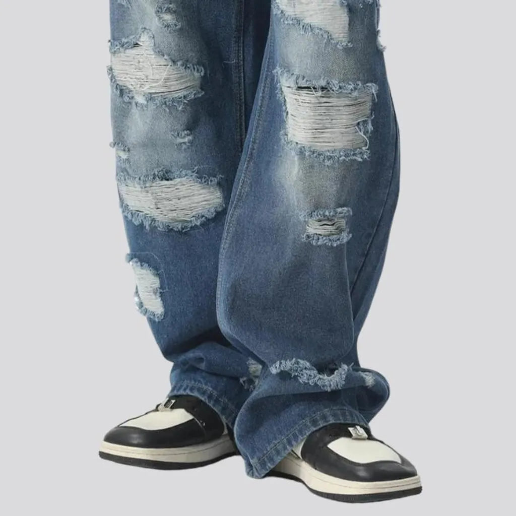 Medium-wash men's floor-length jeans