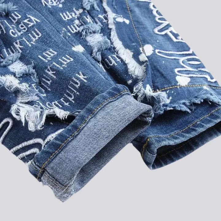 Mid-waist paint-splattered jeans