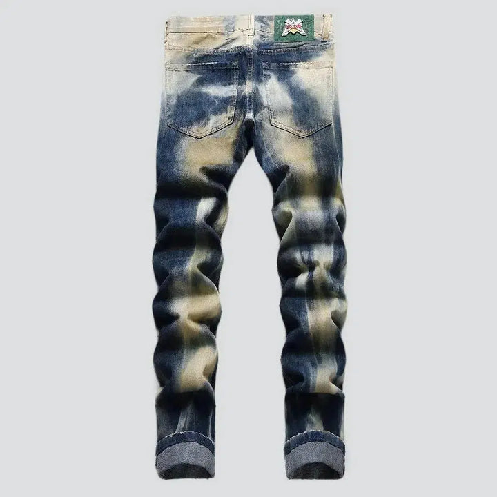 Distressed men's tie-dyed jeans