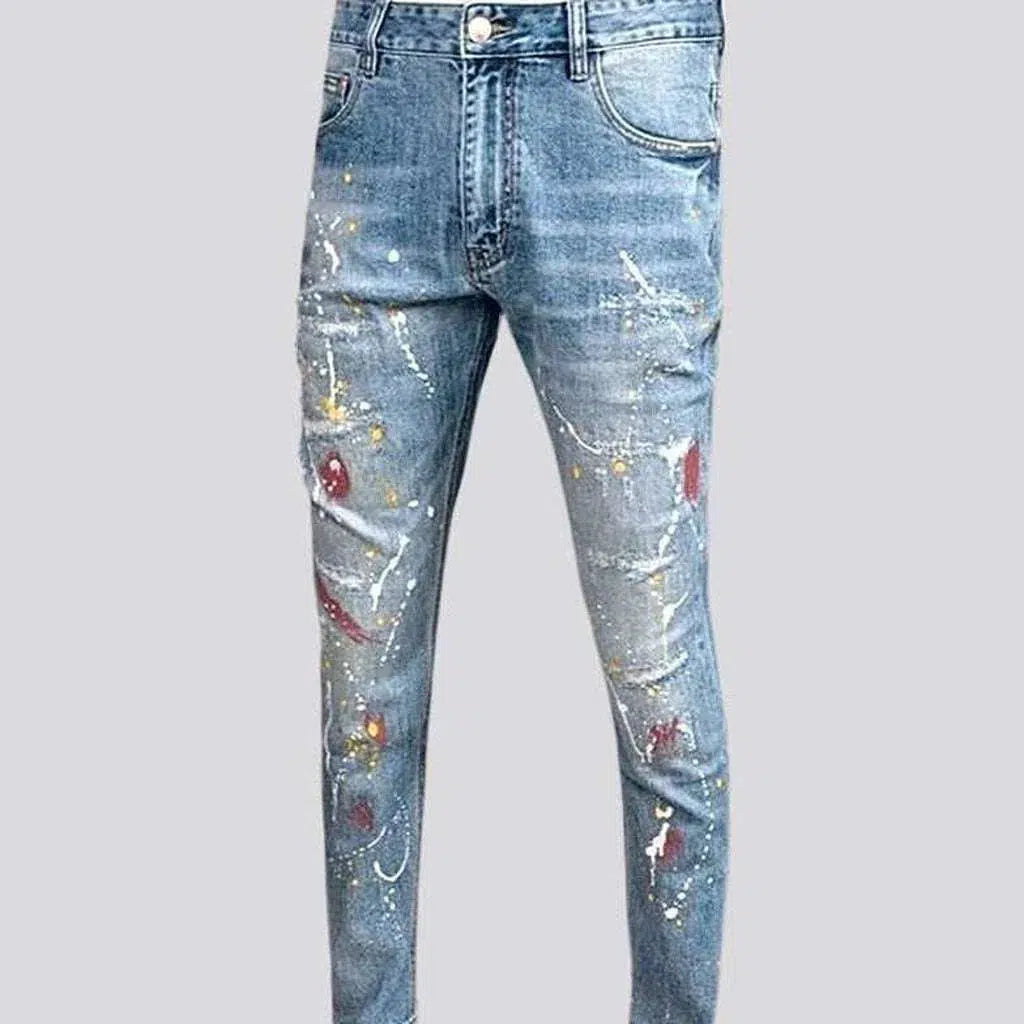 Distressed men's whiskered jeans