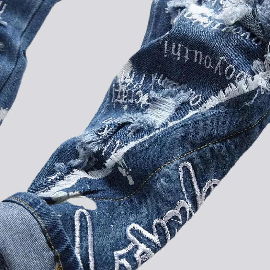 Mid-waist paint-splattered jeans