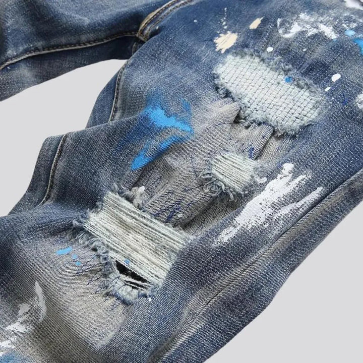 Medium-wash men's painted jeans