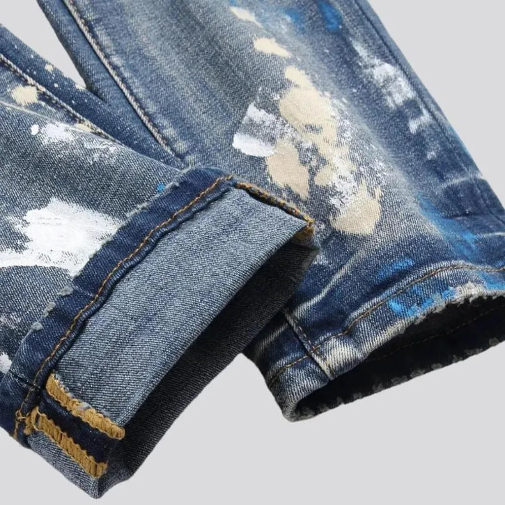 Medium-wash men's painted jeans