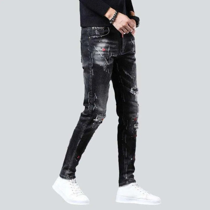 Ripped slightly painted men's jeans