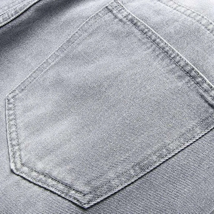 Grey jeans with buttoned pockets