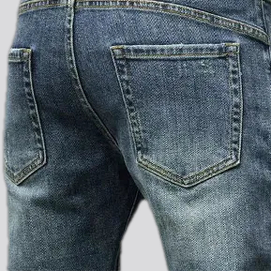 Fashionable distressed stretch men's jeans