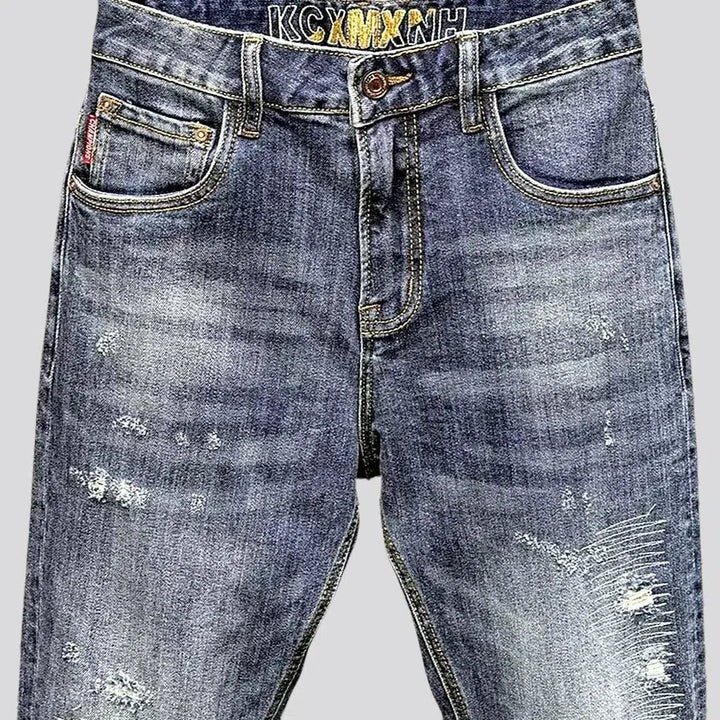 Whiskered men's ripped jeans