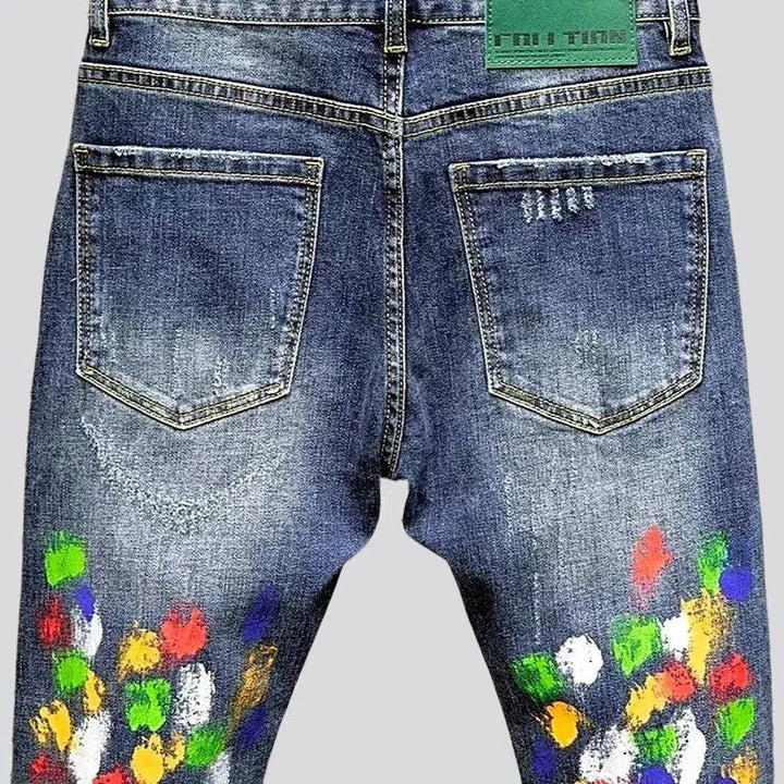 Multi-color stains sanded jeans