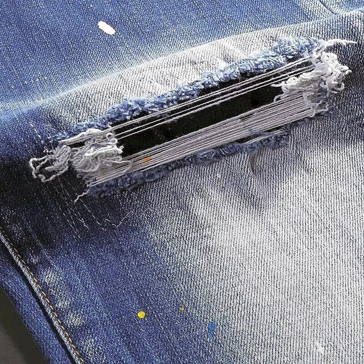 Paint-splattered medium men's wash jeans