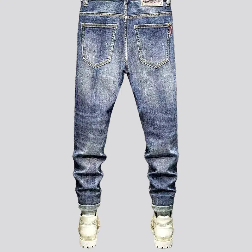 Whiskered men's ripped jeans