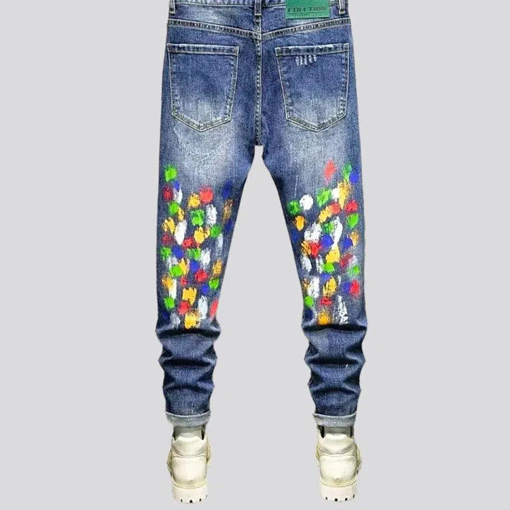 Multi-color stains sanded jeans