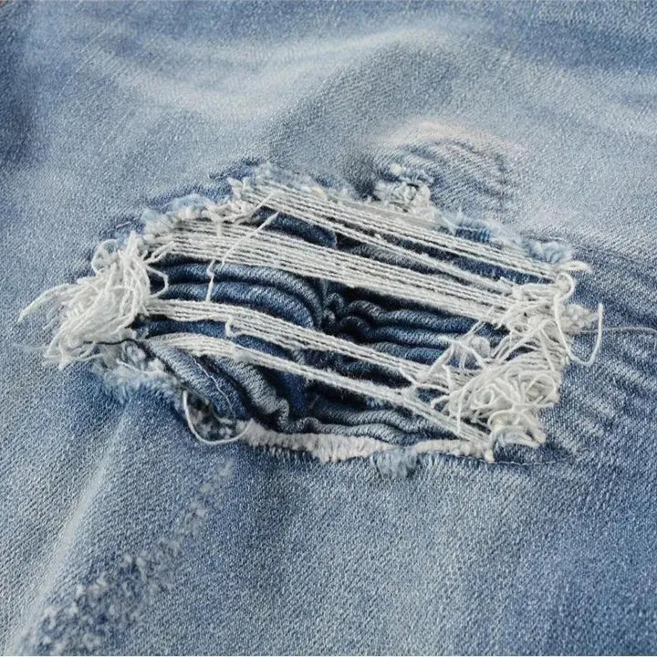 Damaged men's whiskered jeans