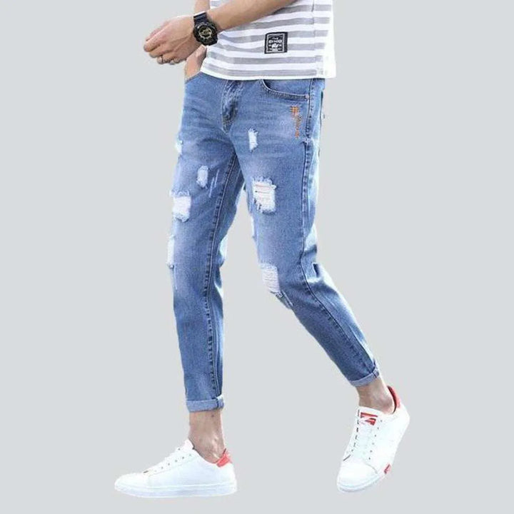Light wash ripped men's jeans