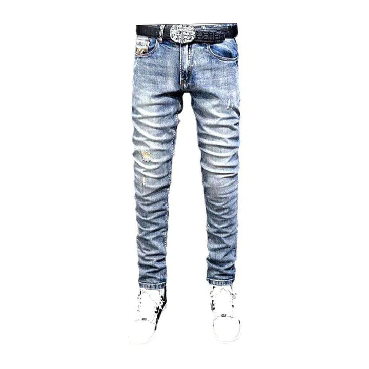 Distressed men's mid-waist jeans