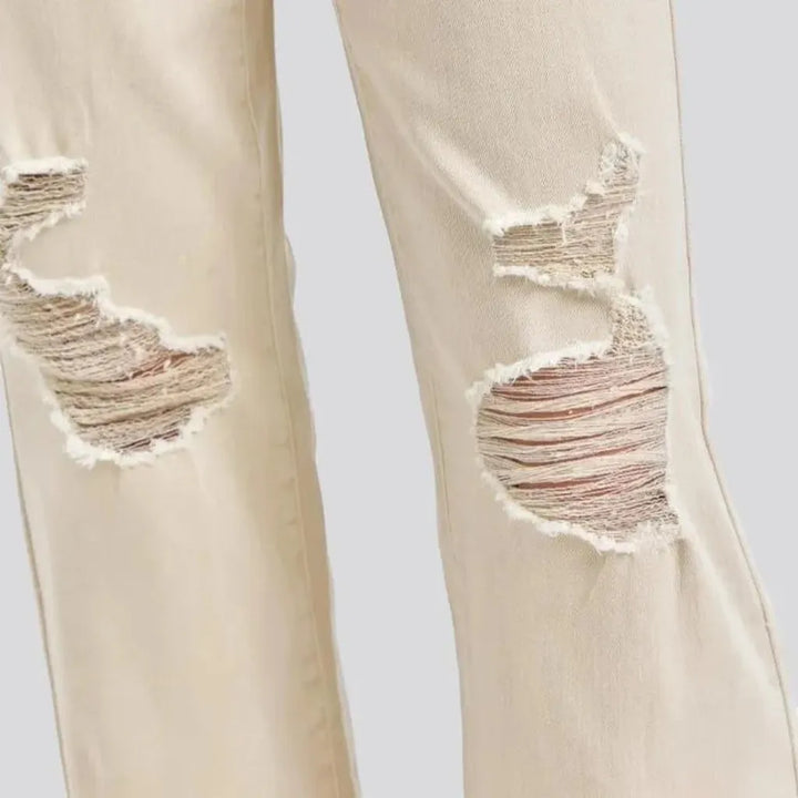 Distressed women's sand jeans